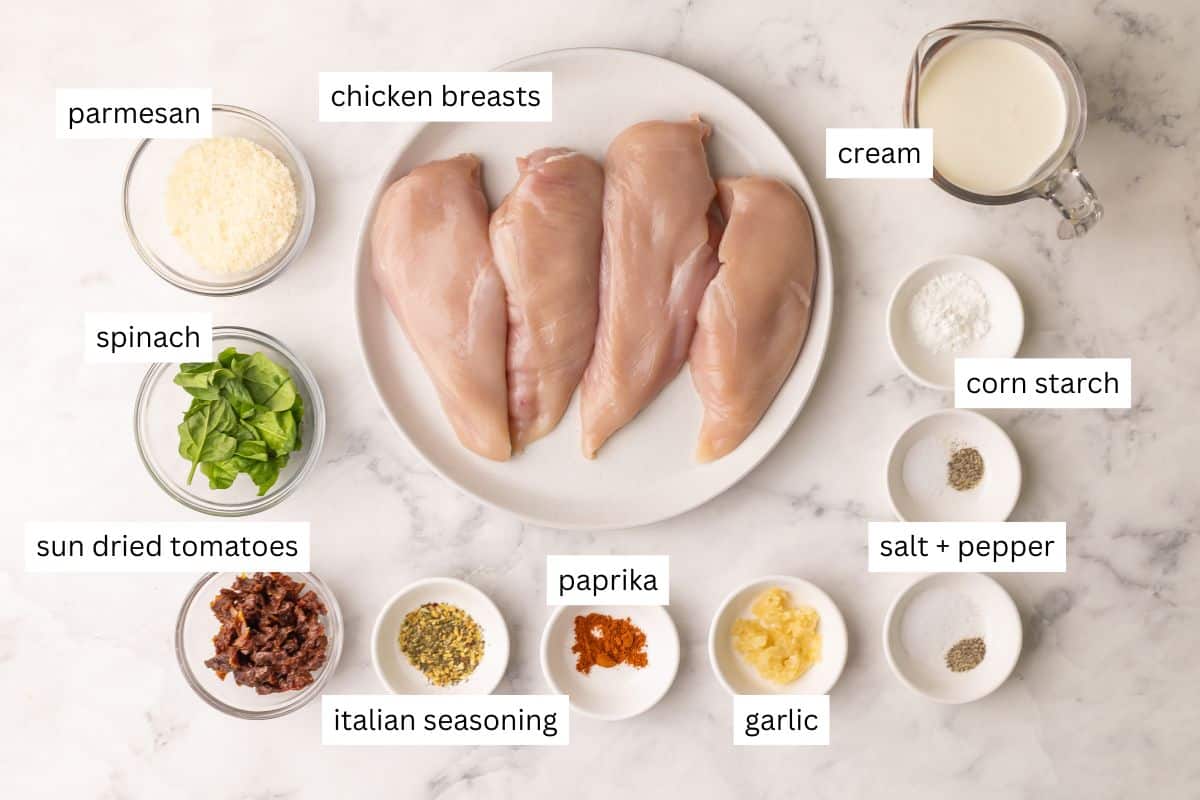 ingredients needed for baked tuscan chicken breasts in bowls and plate.