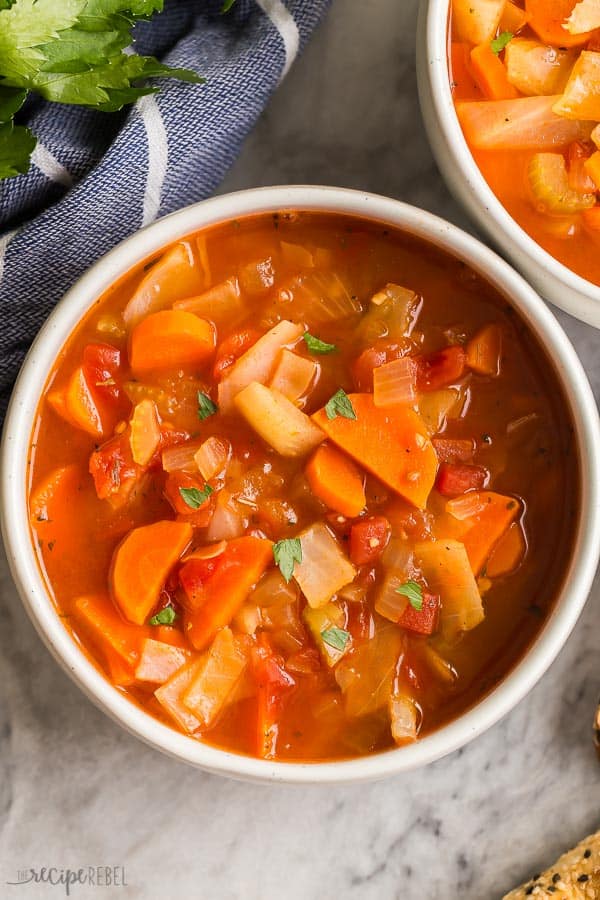 This easy Cabbage Soup is a healthy soup recipe made with just SIX ingredients, including cabbage, carrots, onions, celery, and tomatoes. Dairy free, vegetarian, gluten free and DELICIOUS. #soup #dinner #healthy #healthyrecipes cabbage soup in bowl close up and overhead on marble