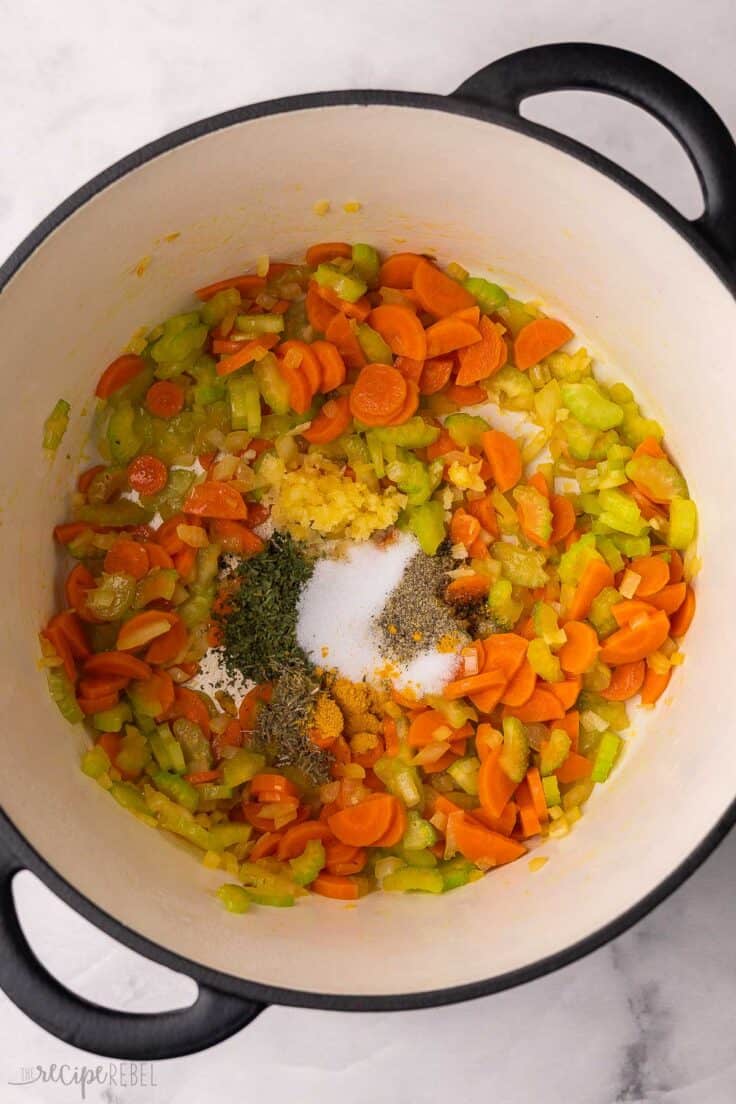 suateed vegetables and spices in large soup pot.