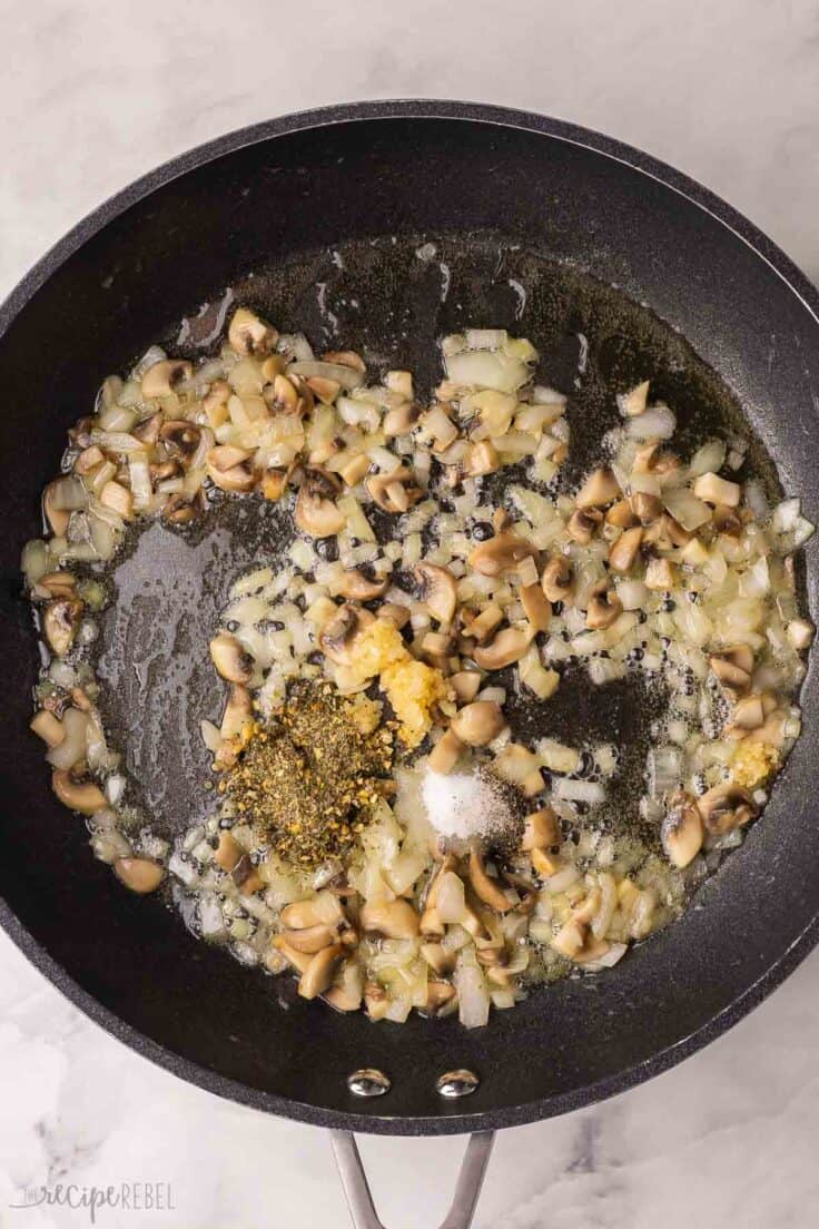 sauteed vegetables in pan with spices added.