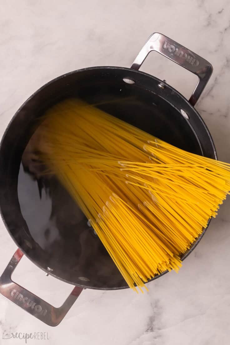 large pot of water with spaghetti added.