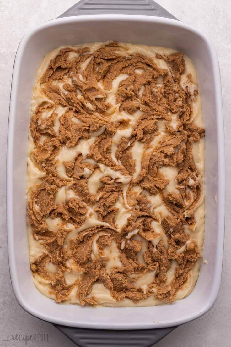 white pan with cinnamon roll cake ready to be baked.
