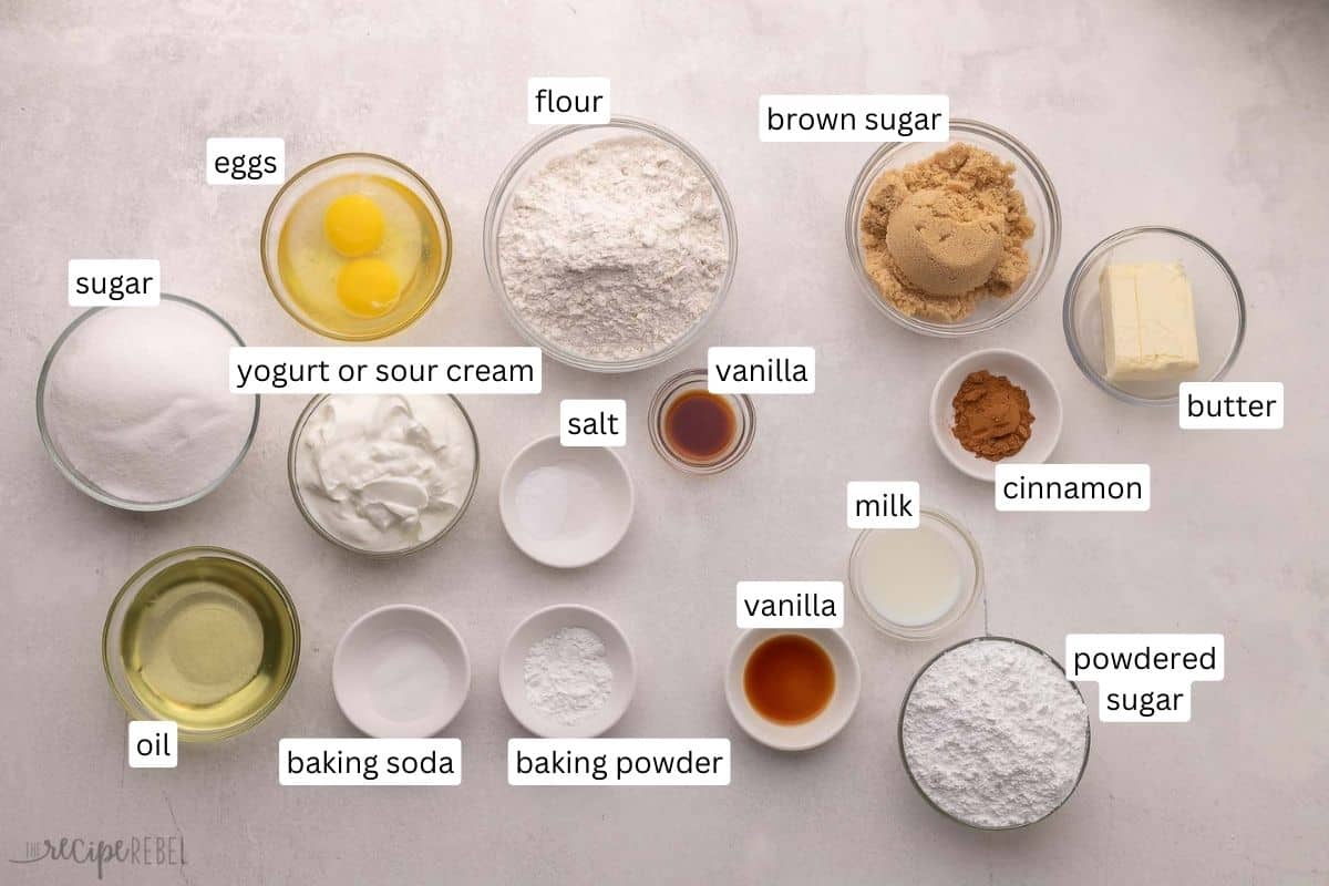 Cinnamon Roll Cake feature a soft homemade cake that's swirled with the most scrumptious cinnamon roll filling! It's baked to perfection in a casserole dish in just 30 minutes before being served with a generous amount of sugary sweet glaze. #cake #dessert #recipe | dessert recipes | cake recipes | cinnamon recipes | brunch | christmas breakfast | christmas dessert | cinnamon roll recipes | thanksgiving breakfast ingredients needed for cinnamon roll cake in bowls.