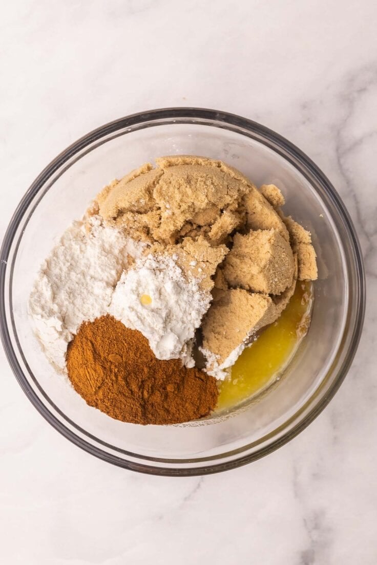 brown sugar and other unmixed ingredients in glass mixing bowl.
