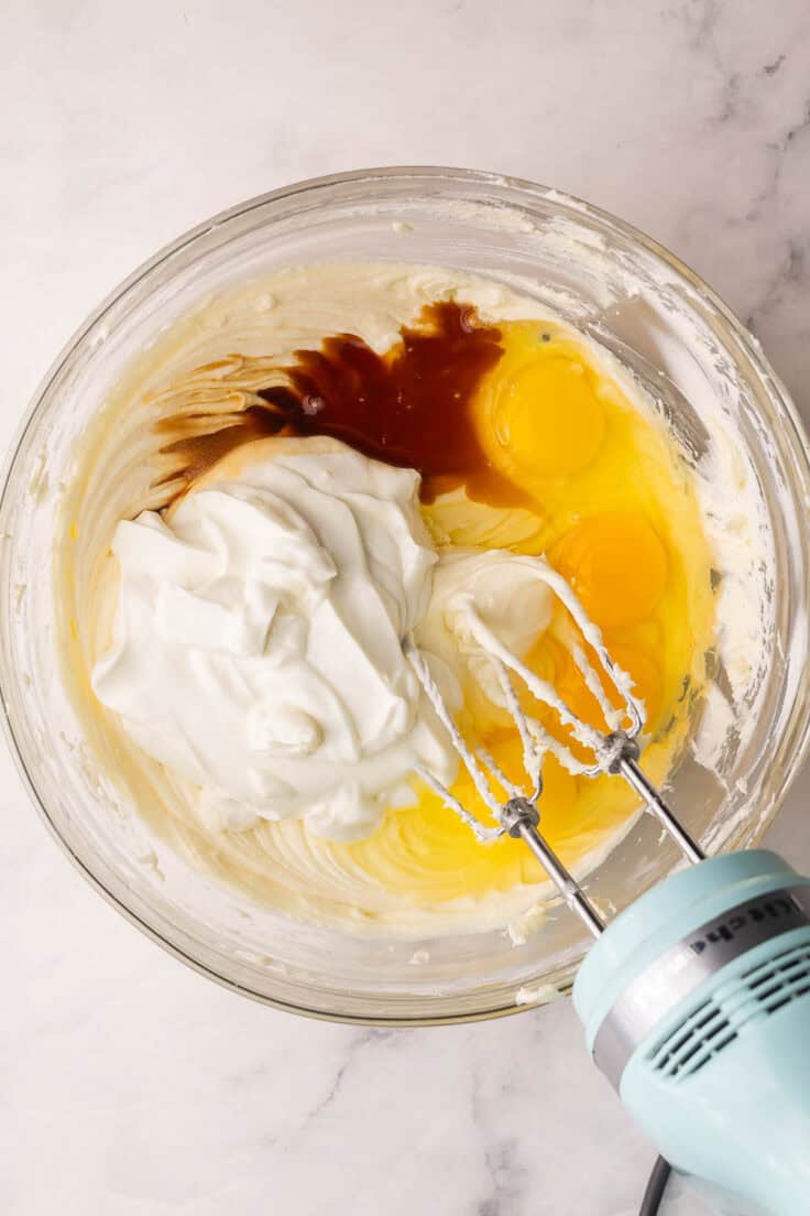 eggs and other ingredients added to cream cheese mixture.