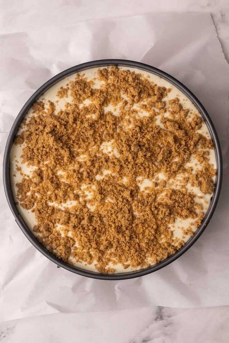 cinnamon roll cheesecake prepared and in pan.