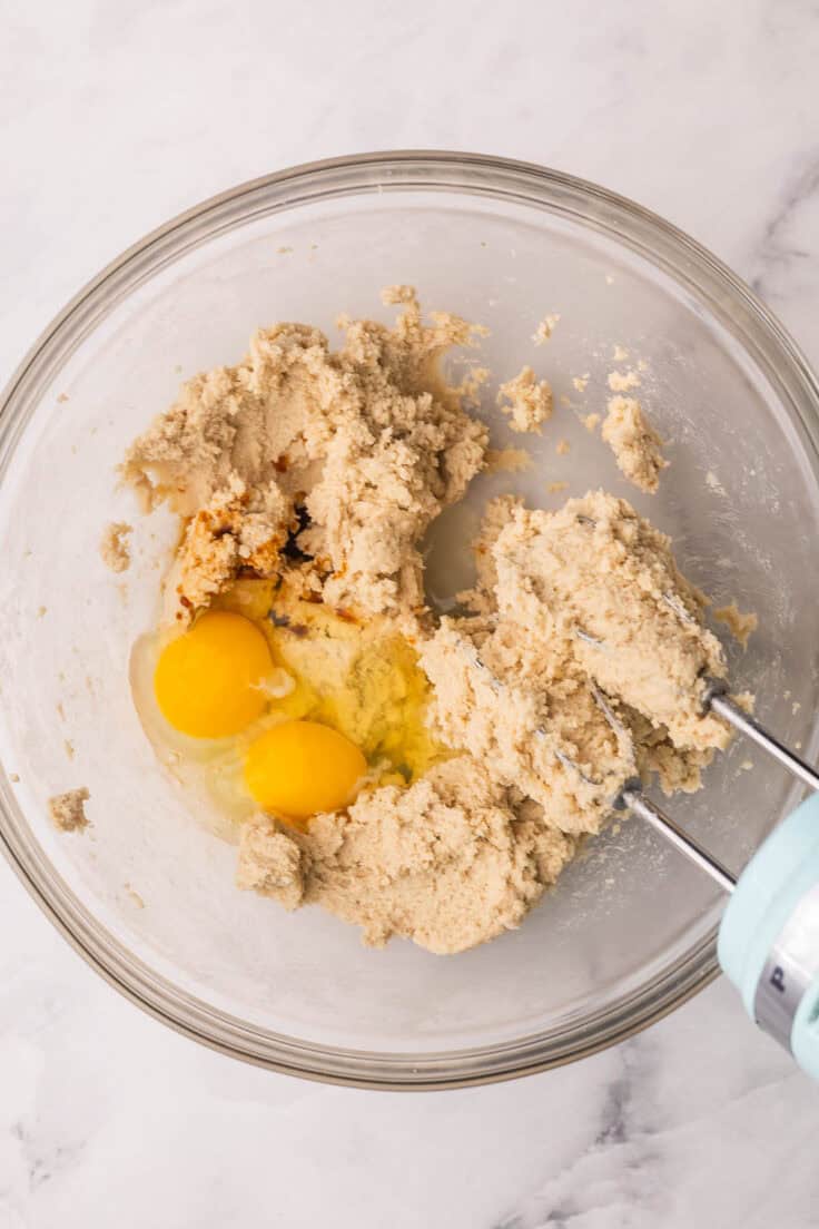 eggs added to mixing bowl with other ingredients.