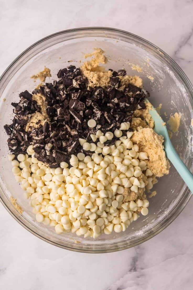 chocolate chips and crushed cookies added to mixing bowl.