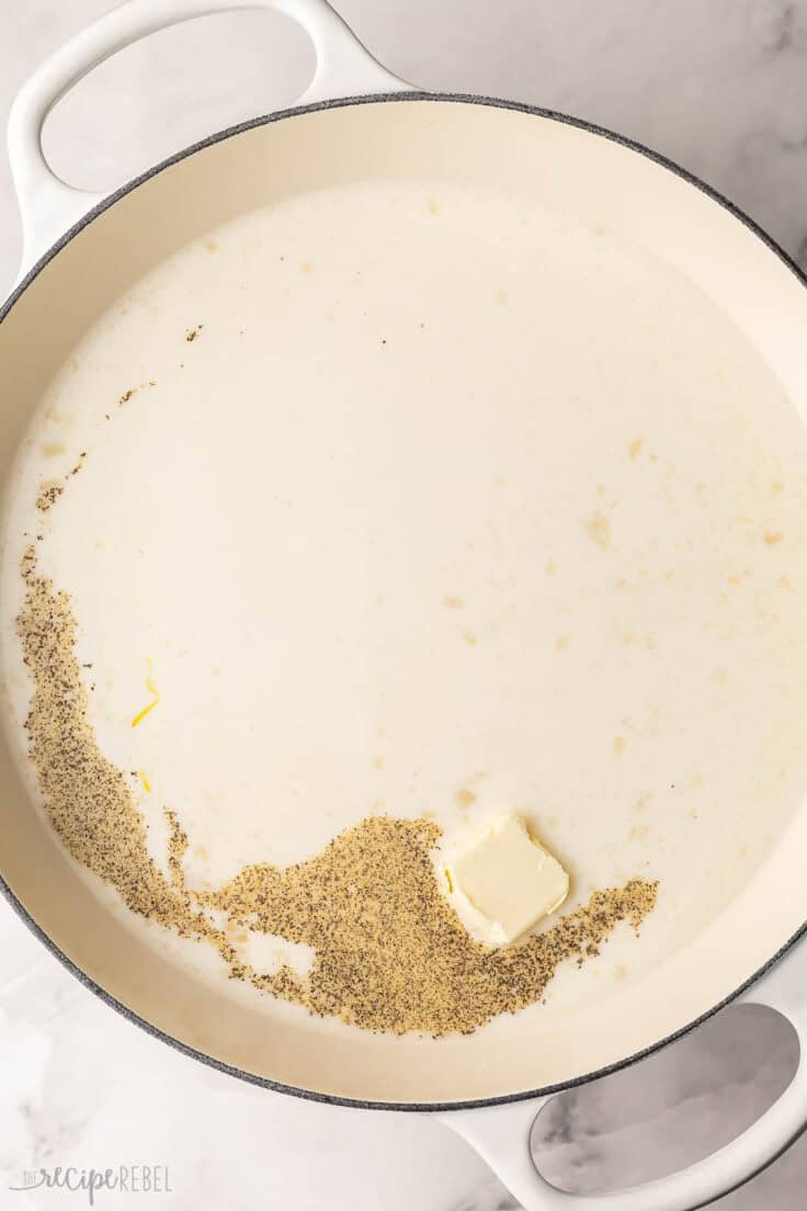 large pan filled with creamy sauce ingredients.