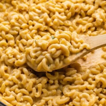 square image of homemade mac and cheese scooped in wooden spoon.