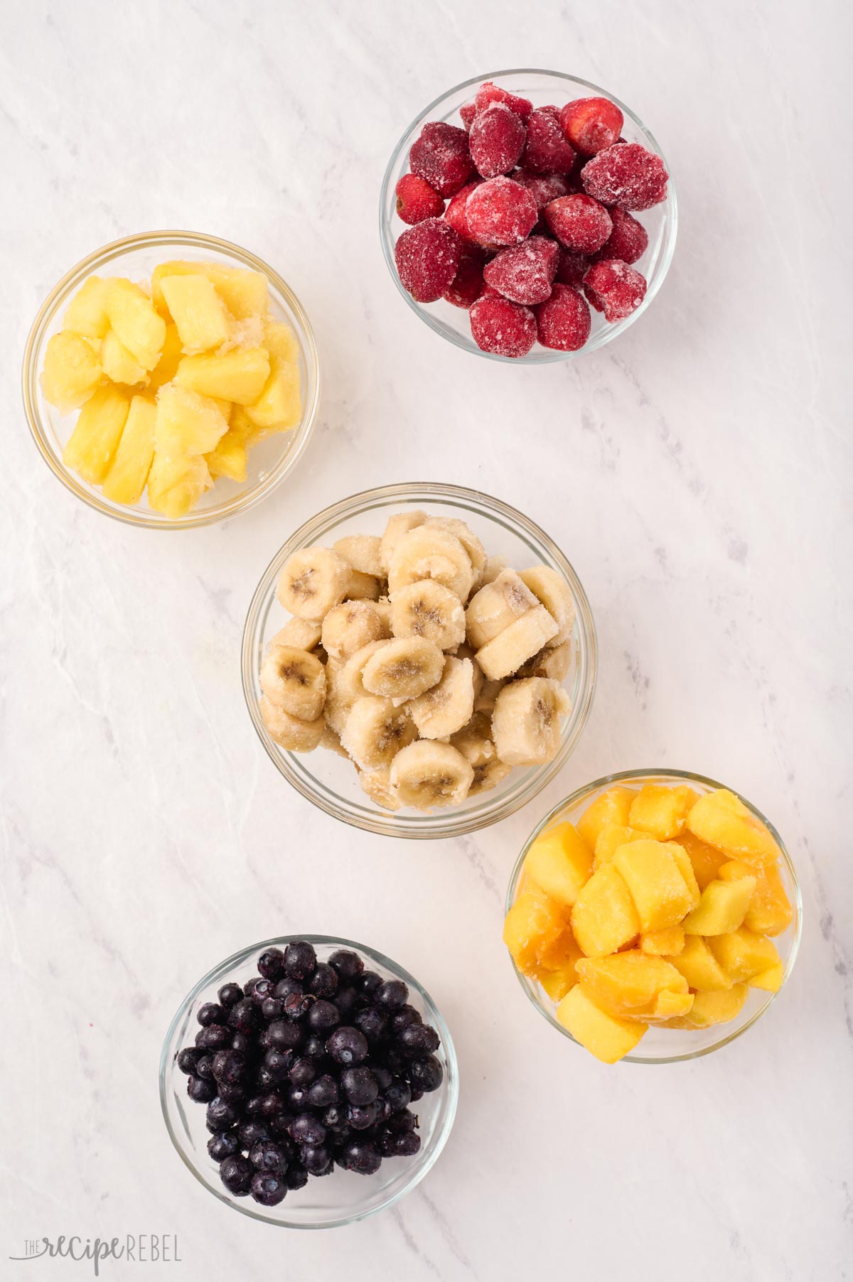 How to Make a Smoothie: my formula for the thickest, creamiest, most delicious fruit smoothie every time! Tons of options for your liquid, your fruit and your add-ins! #smoothie #breakfast #healthy | healthy recipes | healthy smoothie | breakfast smoothie | fruit smoothies frozen fruit options for smoothies in glass bowls