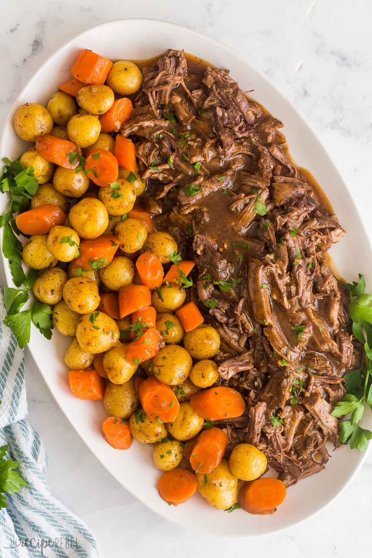 This Instant Pot Pot Roast recipe is an easy, comforting dinner that comes together so quickly in the pressure cooker! With tender veggies (not mushy!), a fall apart tender roast and seasoned gravy. With step by step VIDEO #instantpot #recipes #comfortfood | pressure cooker pot roast | instant pot roast beef | sunday dinner | easy dinner ideas | comfort food | roast beef | instant pot chuck roast | instant pot recipes overhead image of instant pot roast with potatoes and carrots
