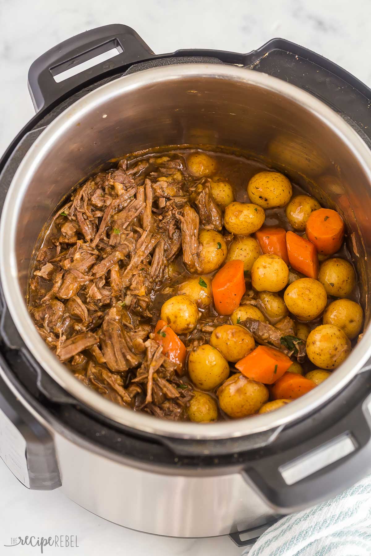This Instant Pot Pot Roast recipe is an easy, comforting dinner that comes together so quickly in the pressure cooker! With tender veggies (not mushy!), a fall apart tender roast and seasoned gravy. With step by step VIDEO #instantpot #recipes #comfortfood | pressure cooker pot roast | instant pot roast beef | sunday dinner | easy dinner ideas | comfort food | roast beef | instant pot chuck roast | instant pot recipes instant pot pot roast with potatoes and carrots in pressure cooker