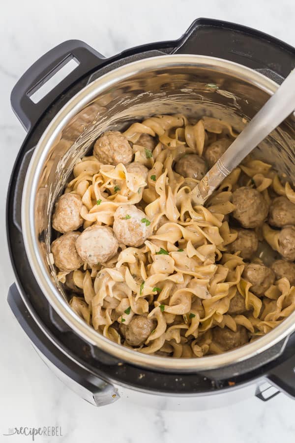 These Instant Pot Swedish Meatballs and Noodles are an easy one pot meal made in the pressure cooker! Made in 30 minutes or less. #instantpot #pressurecooker #meatballs #recipe #recipes instant pot swedish meatballs in pressure cooker with metal spoon in pot