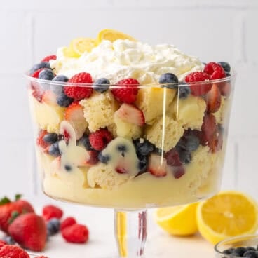 glass bowl filled with lemon berry trifle topped with whipped cream.