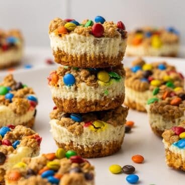 monster cookie cheesecakes stacked up with others all around.