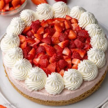 large strawberry cheesecake topped with chopped strawberries.