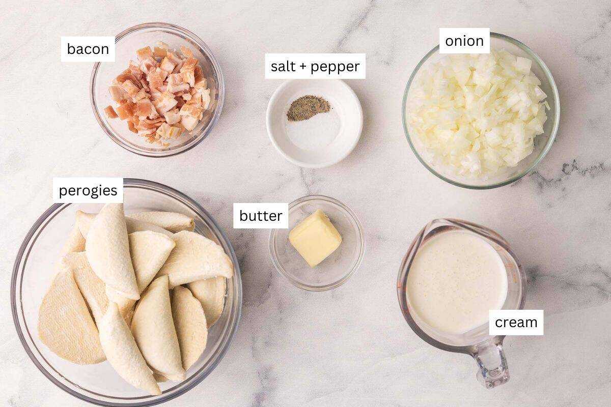 This Perogies recipe with Bacon and Onions recipe is made with frozen perogies swimming in a creamy sauce with smoky bacon and onions. Ready in 35 minutes, it's the perfect side dish for the holidays or whenever you're craving something comforting. | dinner | recipe | easy dinner ideas | pierogi | comfort food | skillet meals ingredients needed for perogies with bacon and onions in bowls.