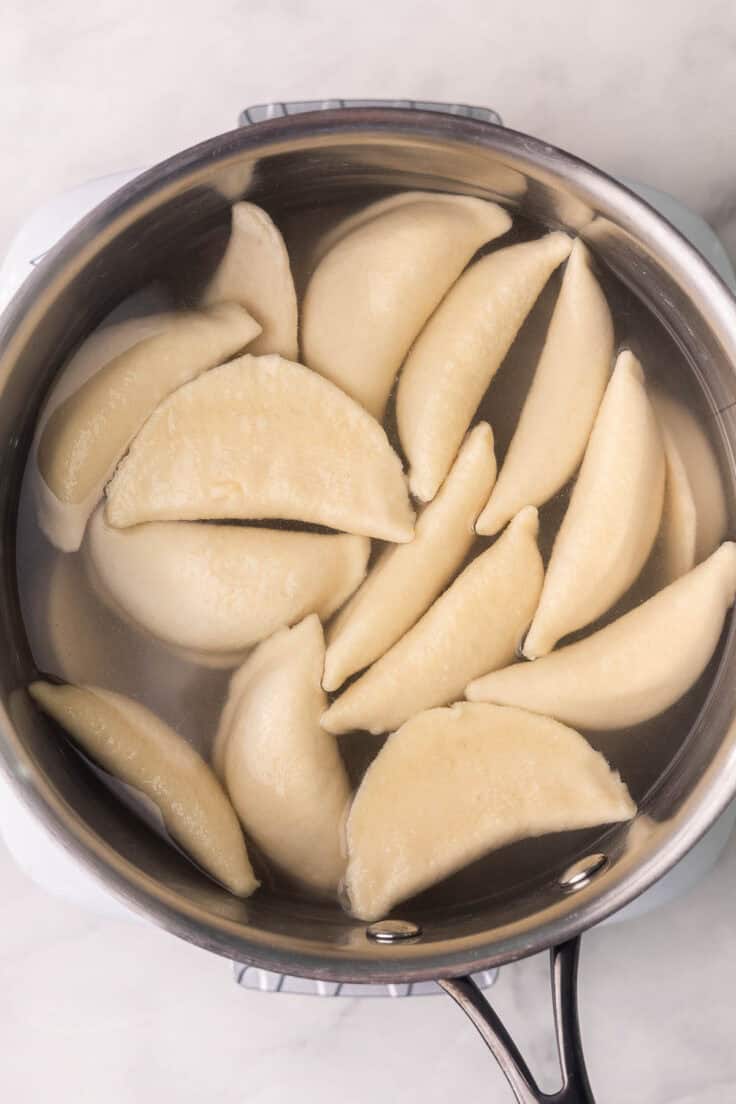 perogies in a pot of hot water.