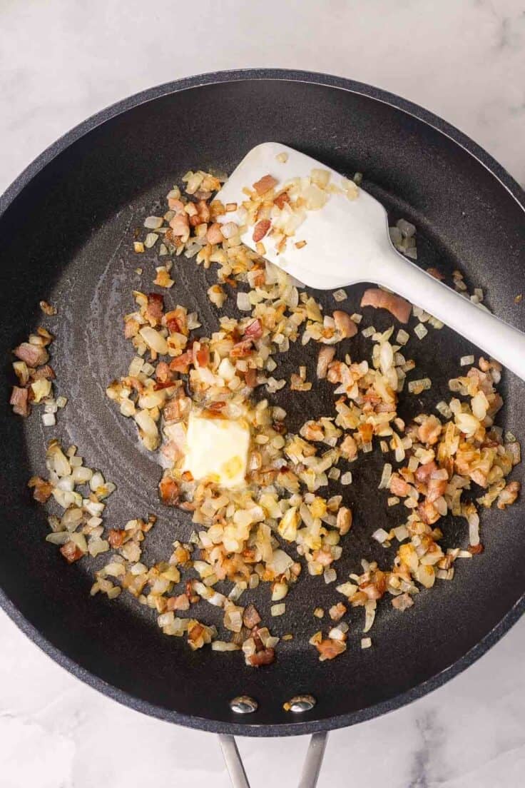 bacon, onions and butter in black frying pan.