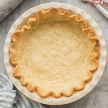 square image of golden pie crust in pie plate no filling.