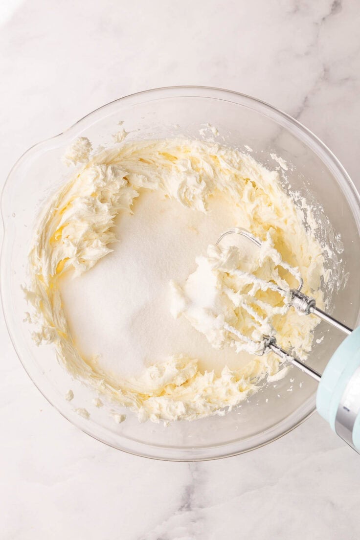 mixing bowl with beat cream cheese and sugar added.