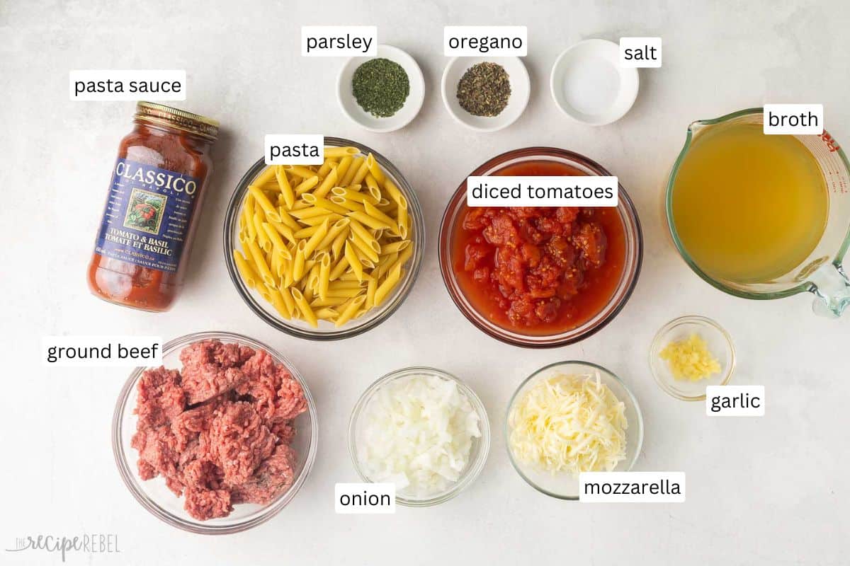 This Slow-Cooker Baked Ziti is made completely in the crockpot—even the pasta! It is so much easier than the traditional version but packs all of the same flavor! The recipe includes a step-by-step video. #recipe #dinner #slowcooker | slow cooker dinner | crockpot meals | crockpot recipes | slow cooker recipes | ground beef recipes | pasta recipe | easy dinner ideas | ground beef pasta ingredients needed for slow cooker baked ziti in bowls.