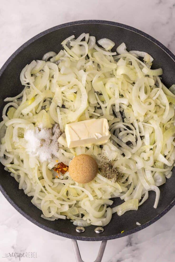 large black pan filled with onions and other ingredients.