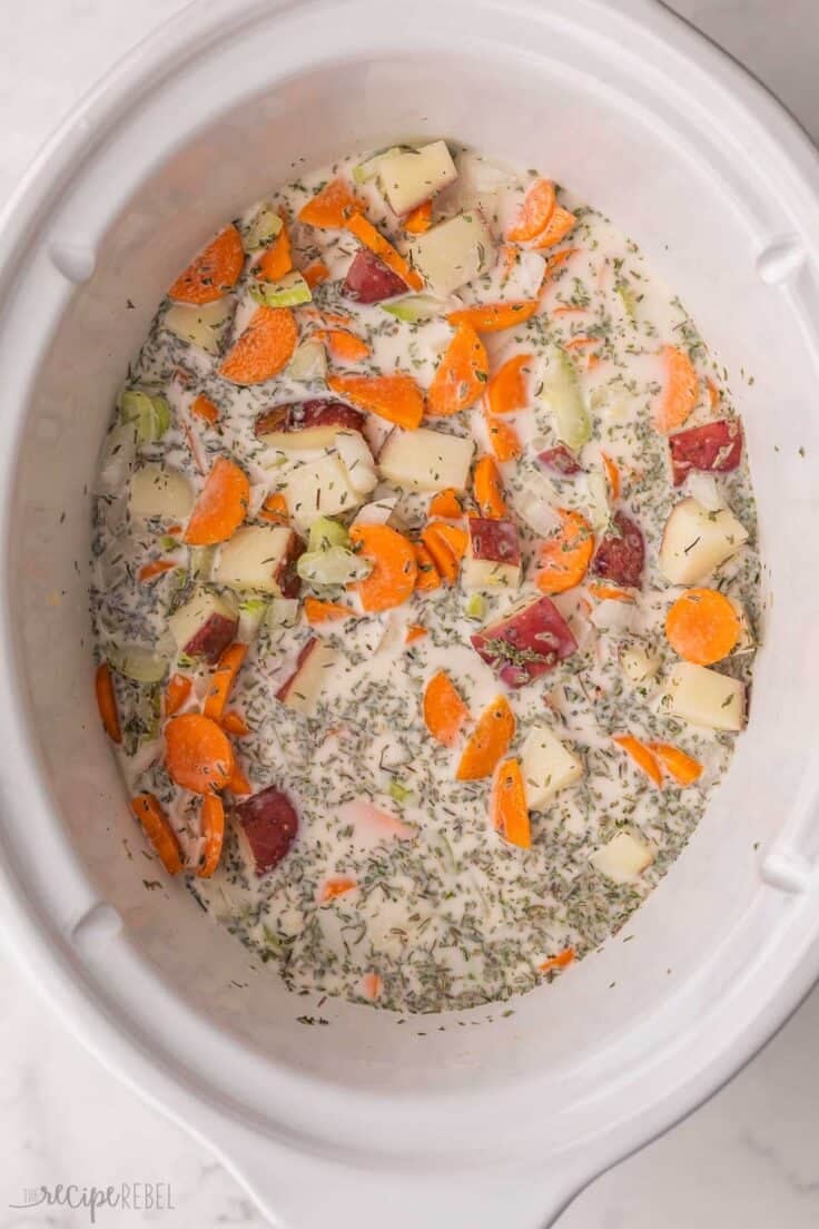 cream mixture added to vegetables and other ingredients in slow cooker.