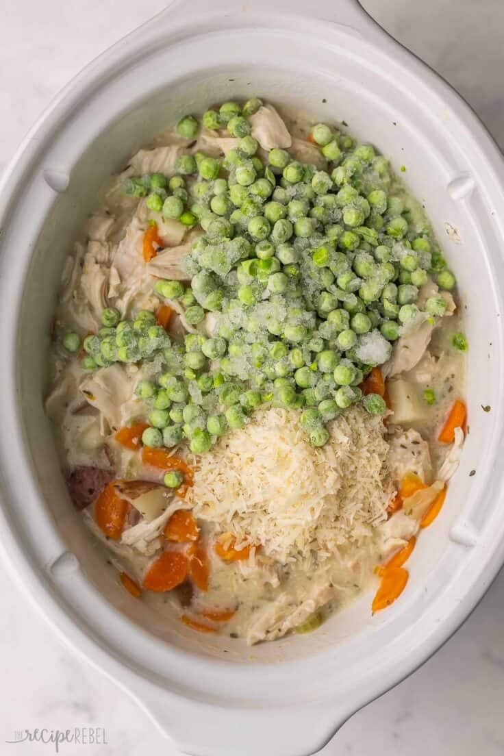 frozen peas added to other ingredients in slow cooker.